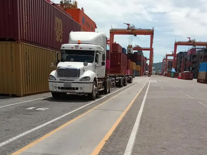 Unidad de la red de socios con un full de chasis, en un carril de la terminal de contenedores